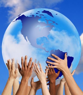 Hands touching a globe --- Image by © Royalty-Free/Corbis